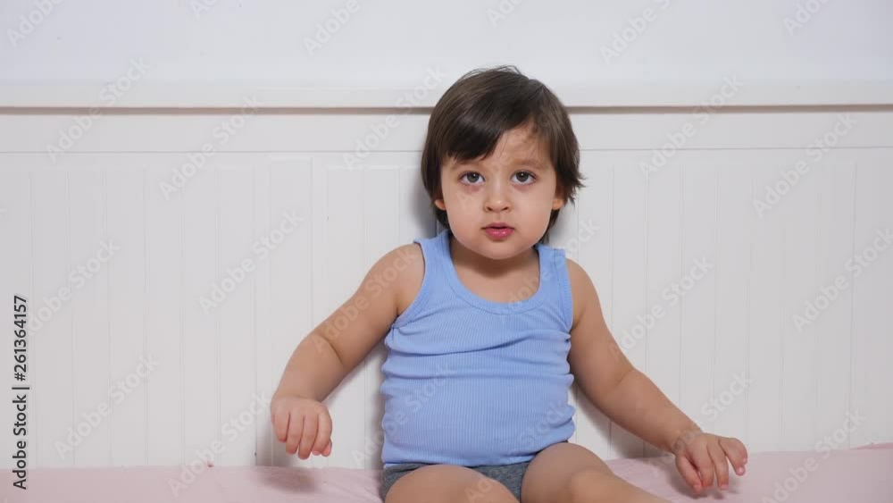 baby boy in blue t-shirt and gray shorts jumping baby boy in blue t-shirt and gray shorts jumping