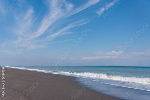 Cloudscape and Volcanic Black Sand Beach and Blue Ionian Sea in Sicily