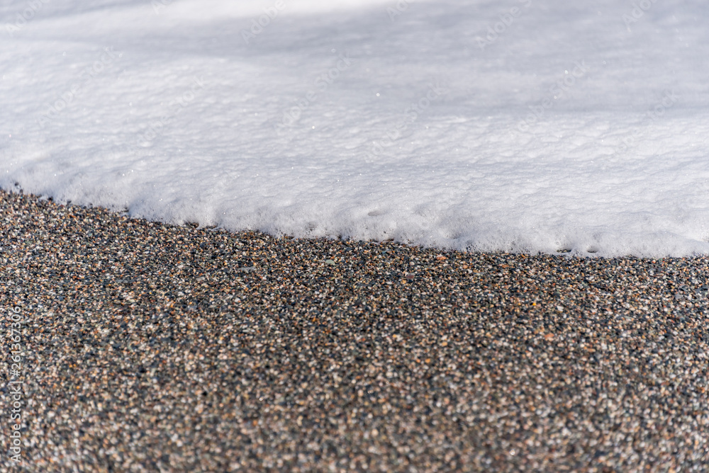 White Foam of Surf on a Black Volcanic Sand Beach in Sicily White Foam of Surf on a Black Volcanic Sand Beach in Sicily