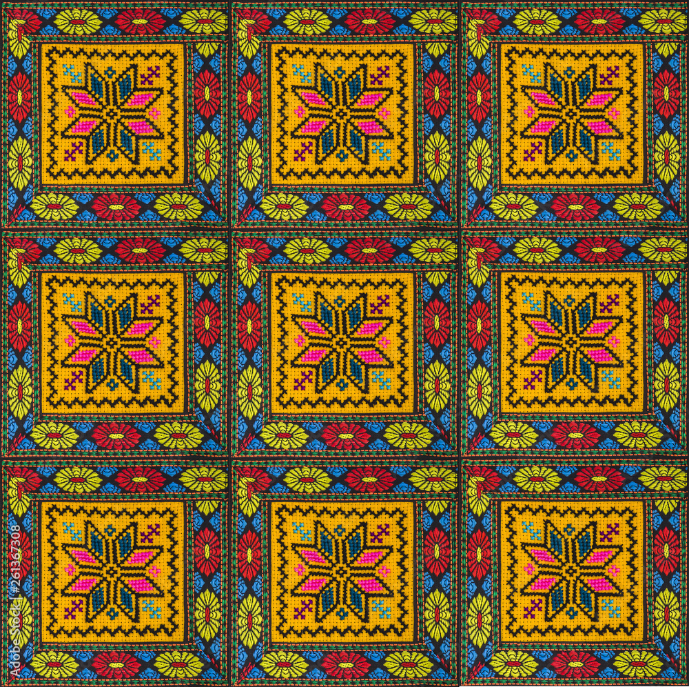 Seamless pattern of squares with ornaments, embroidered with colored threads