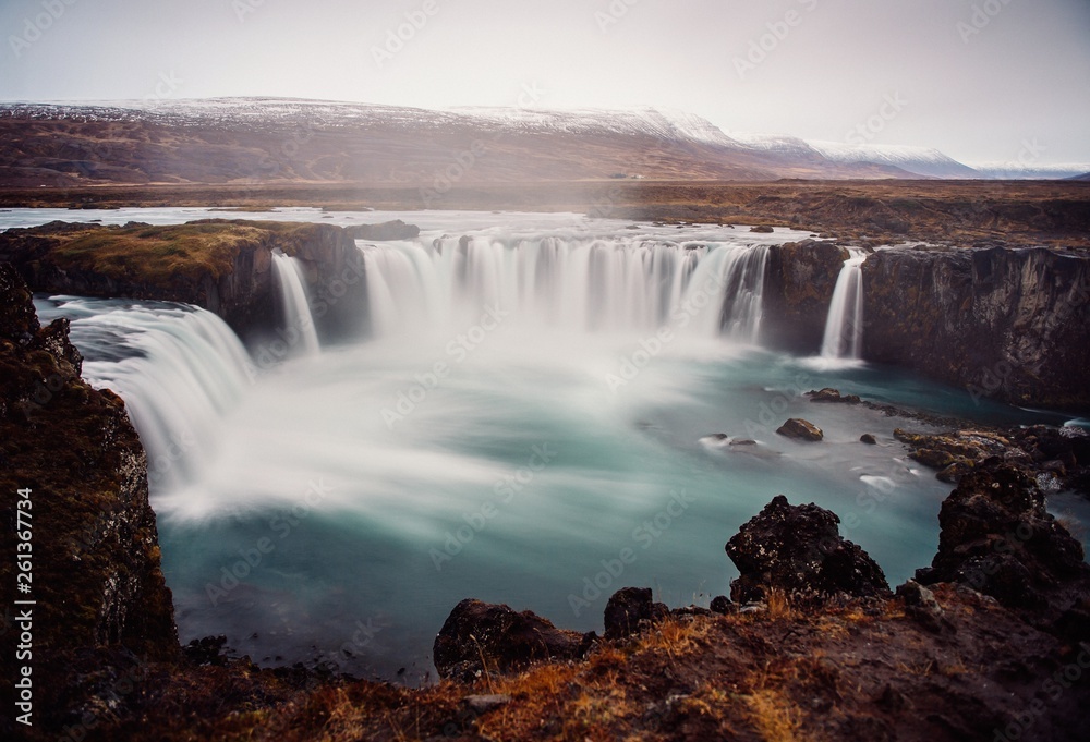 From above picturesque view of river rapids between fields and cloudy sky in Iceland From above picturesque view of river rapids between fields and cloudy sky in Iceland