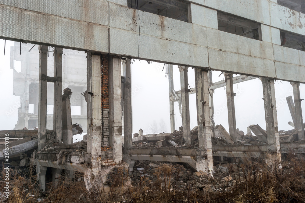 The remains of a large building destroyed in a foggy haze. Background.
