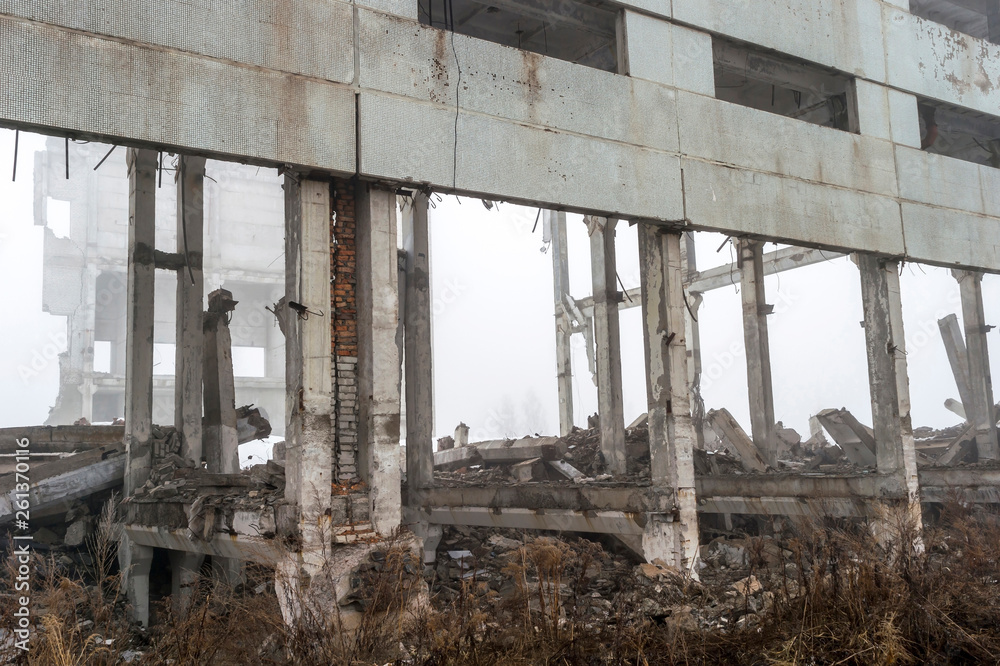 The remains of a large building destroyed in a foggy haze. Background. The remains of a large building destroyed in a foggy haze. Background.