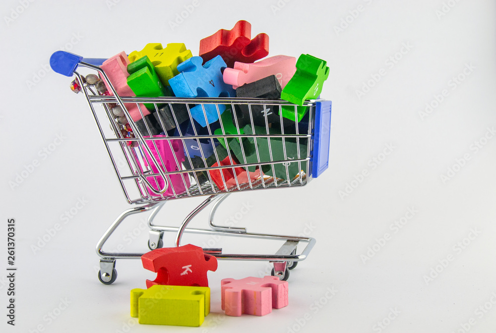 Time to play. Kids wooden toys, colorful puzzles in miniature shopping carts with white background Time to play. Kids wooden toys, colorful puzzles in miniature shopping carts with white background