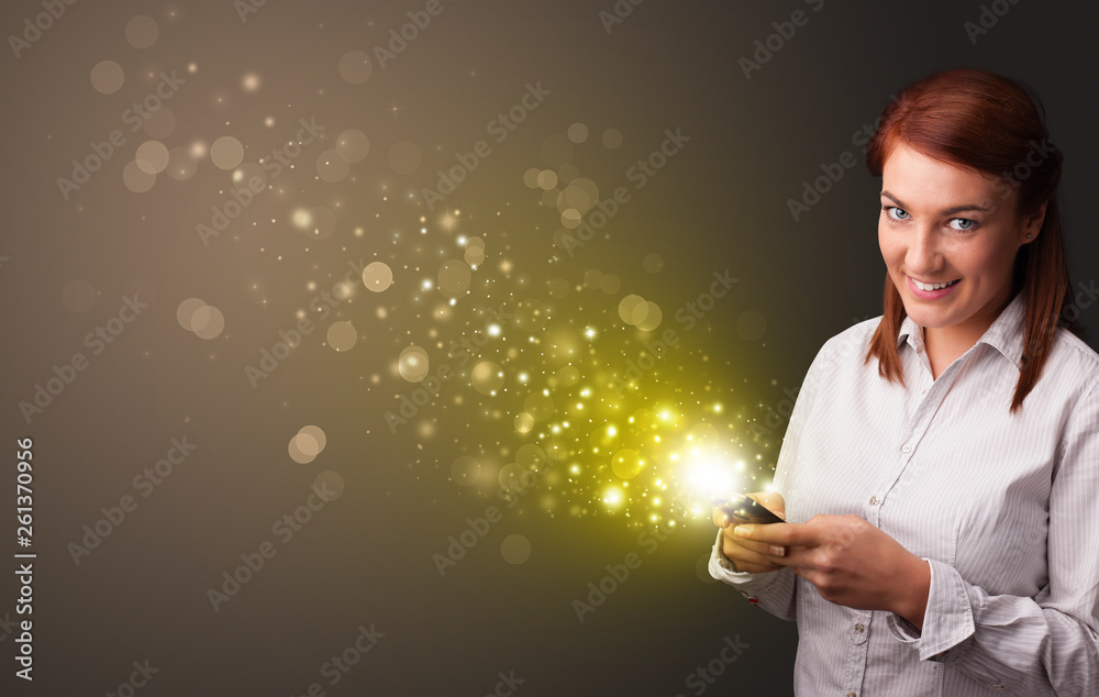Person using phone with gold sparkling concept
Person using phone with gold sparkling concept