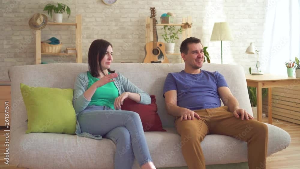 Young man farted sitting on the couch next to a young woman who wore a respirator from the smell Young man farted sitting on the couch next to a young woman who wore a respirator from the smell