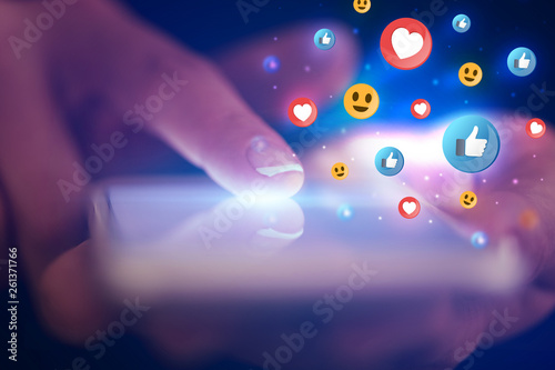 Finger touching phone with social media concept and dark background
