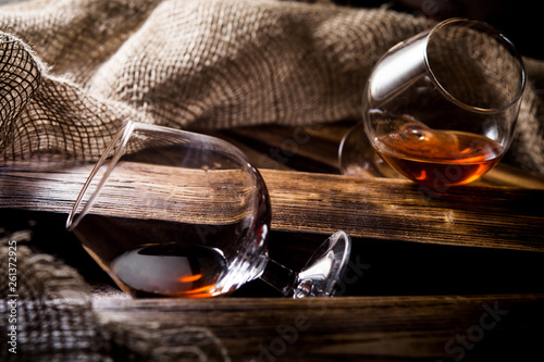 glasses of whiskey or cognac on a wooden background