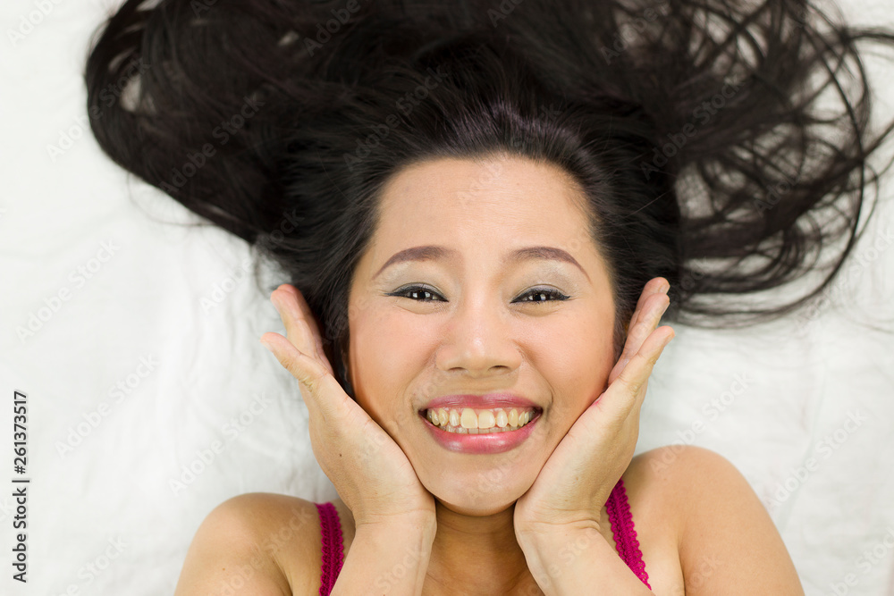 Closeup portrait of happy asian women lying on ground with black long hair. acting smile, fun, Closeup portrait of happy asian women lying on ground with black long hair. acting smile, fun,