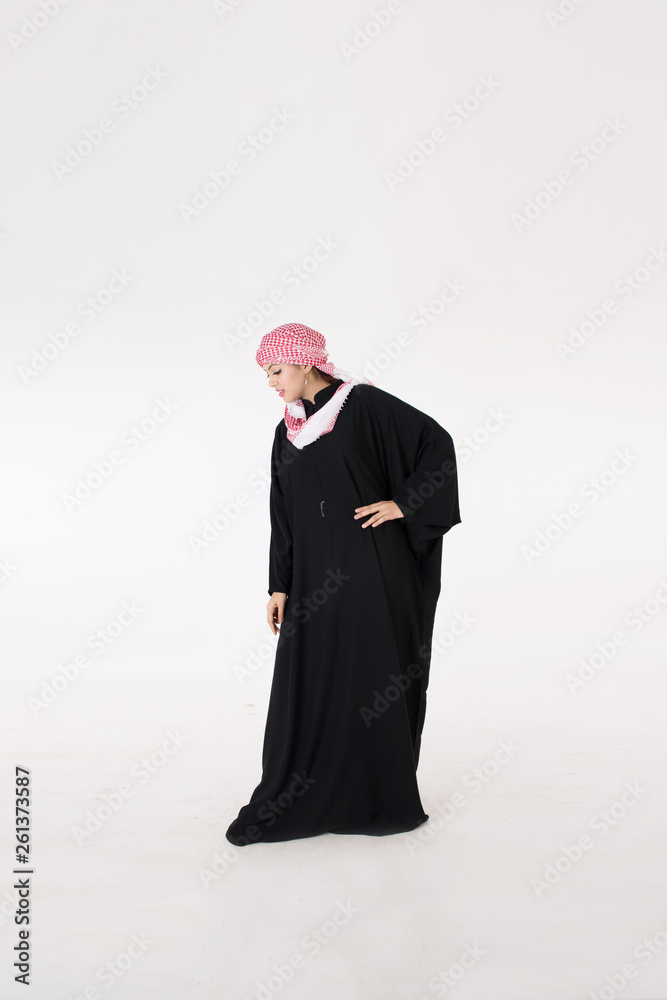 pretty young Arab female in traditional dress posing on white background