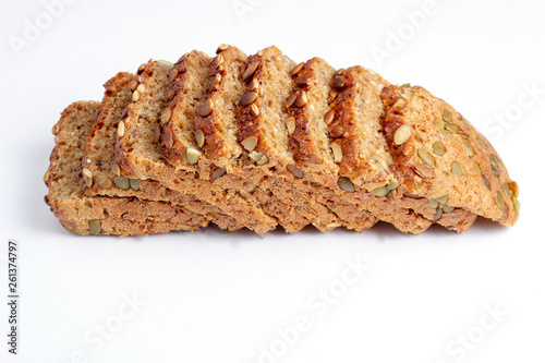 Photos Slice of multigrain bread with sunflower and pumpkin seeds and flax seed on a wh