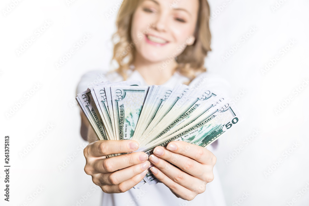 Happy young smiling woman hold us dollar money in hand over white background. Happy young smiling woman hold us dollar money in hand over white background.