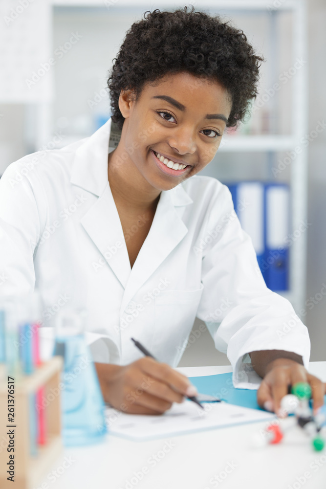 happy medical student taking notes for research