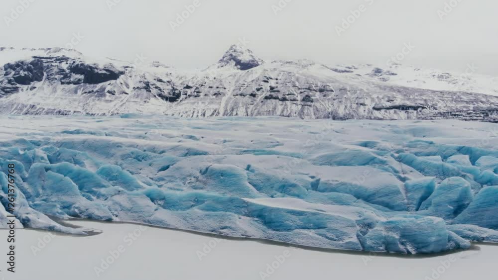 Beautiful glaciers flow through the mountains in Iceland. Aerial view and top view. Beautiful glaciers flow through the mountains in Iceland. Aerial view and top view.