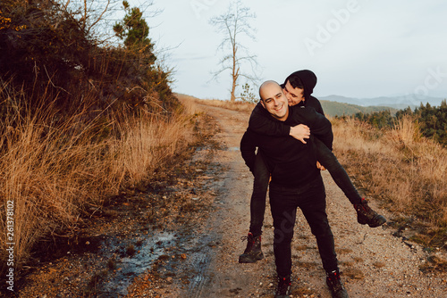 Man doing piggyback to boyfriend photo