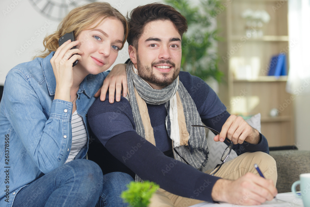 girl using smartphone and boyfriend makes notes girl using smartphone and boyfriend makes notes