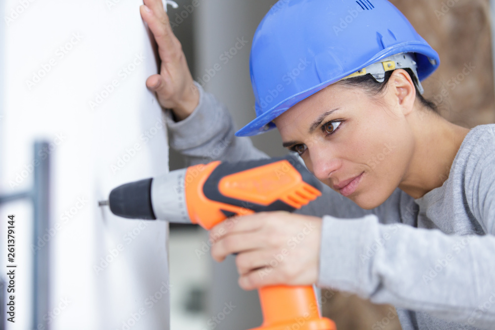 confident happy female builder with drill tool confident happy female builder with drill tool