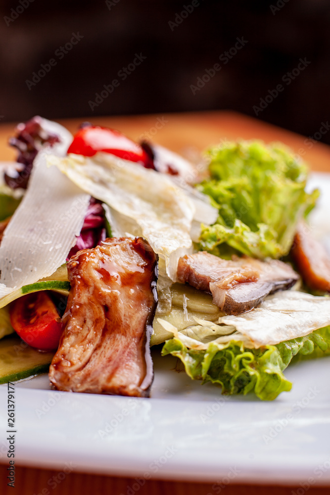 Salad with smoked catfish, carrots and miso dressing.The work of a professional chef. Dish from a restaurant Close-up.