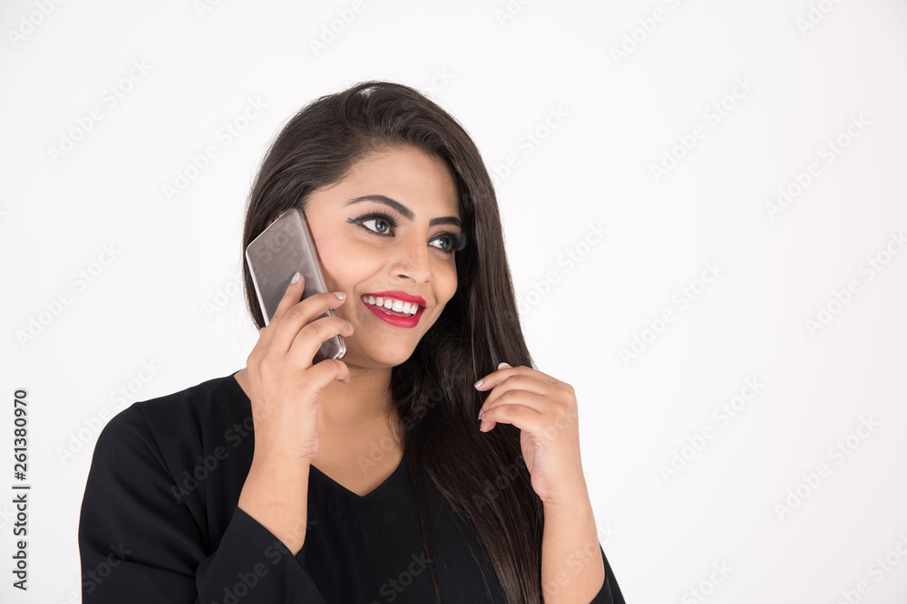 Arab woman in traditional dress using cell phone on white background Arab woman in traditional dress using cell phone on white background