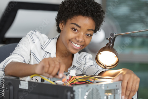 female electronic engineer repairing pc