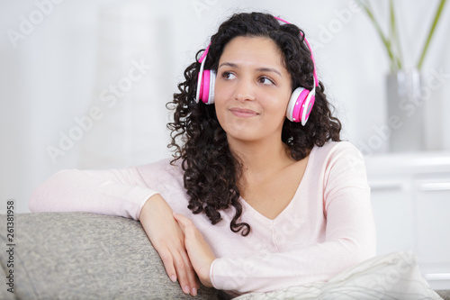 portrait of attractive cheerful pretty positive woma on the sofa photo