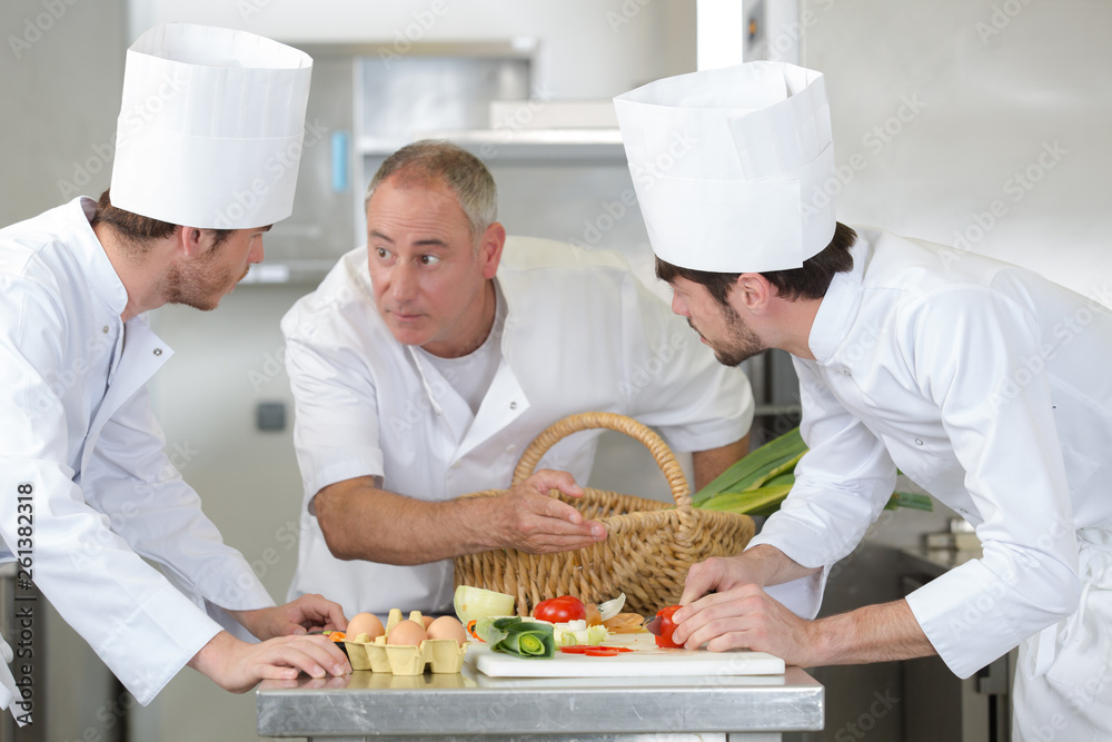 chef talking to the interns in the kitchen