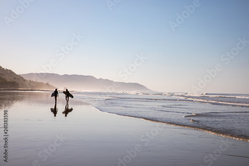 Surfer walking along the Beach in Santa Teresa at the Pacific in Costa Rica photo