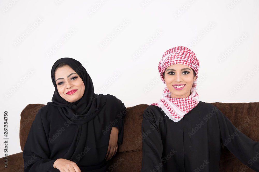 Two Arab Women sitting on sofa chair