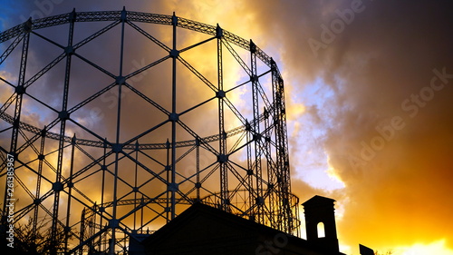Fotografi View of the gasometer at sunset with cloudy sky, a structure designed in the nin
