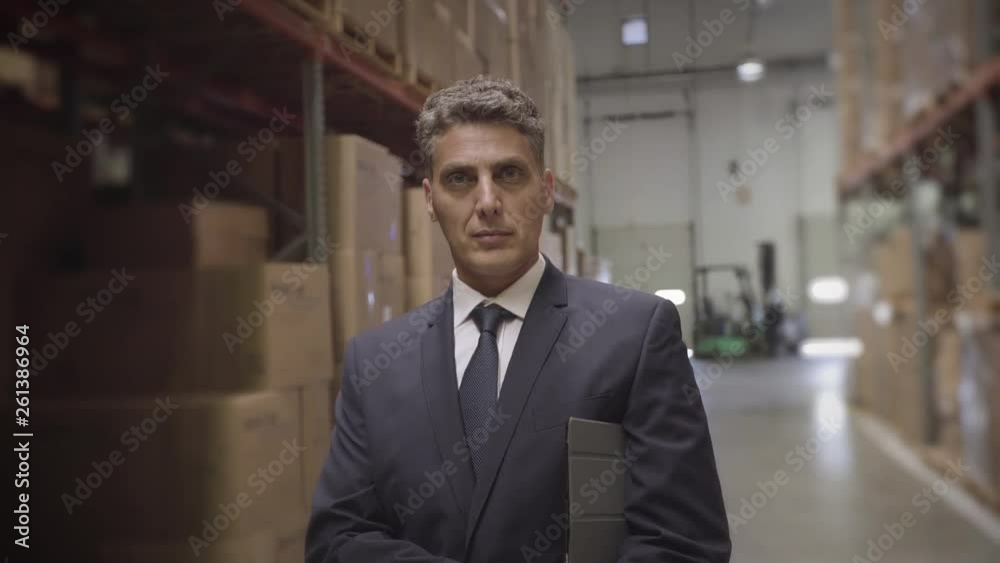 Medium shot of portrait of businessman with digital tablet in warehouse Medium shot of portrait of businessman with digital tablet in warehouse