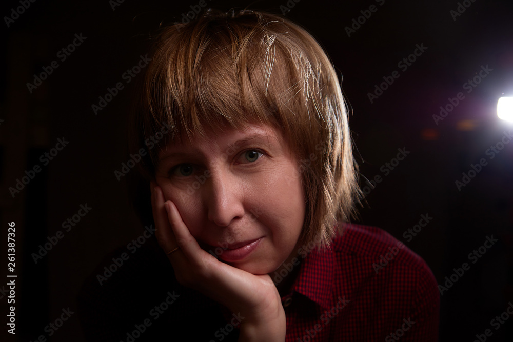 Portrait of ugly but sweet girl with chubby cheeks and black background