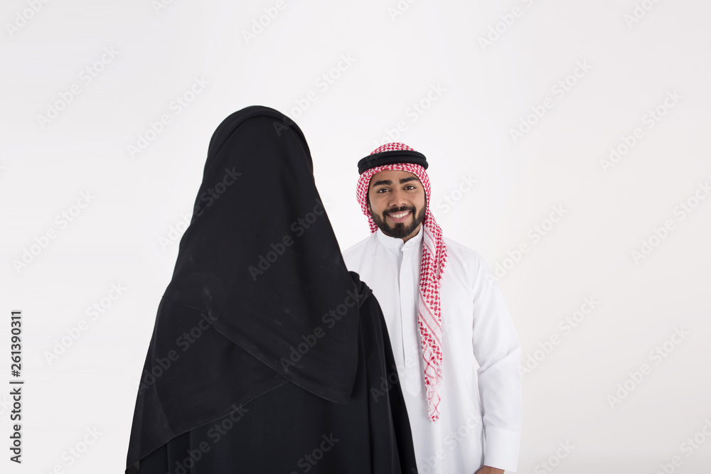 arab couple smiling and standing on white background