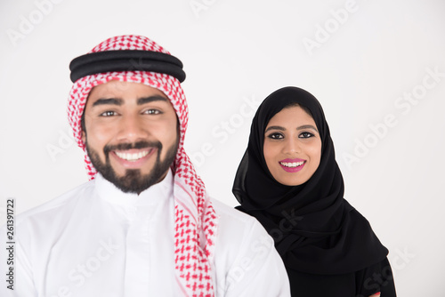 Fototapeta arab couple smiling and standing on white background