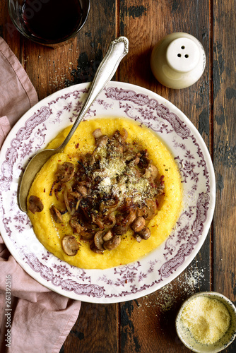 Polenta with fried mushrooms, parmesan cheese and caramelized onion.Top view with copy space. photo