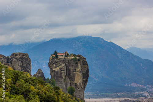 picturesque dramatic scenery highland  landscape with christian monastery pilgrimage touristic heritage site in Europe and gorgeous mountain background in cloudy gray day weather © Артём Князь