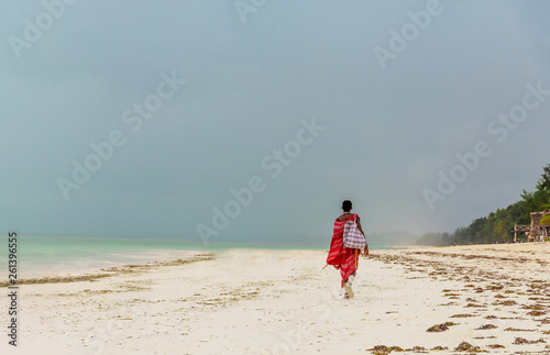 One unrecognizable masai man goes into the distance