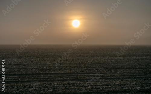 Spring sunset over agricultural field