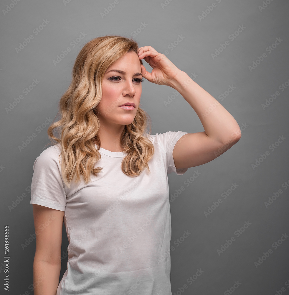A woman thinks holding her head or has a headache. A woman thinks holding her head or has a headache.