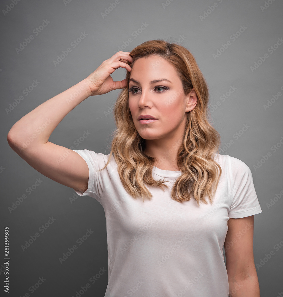 Young attractive woman posing over gray background. Young attractive woman posing over gray background.