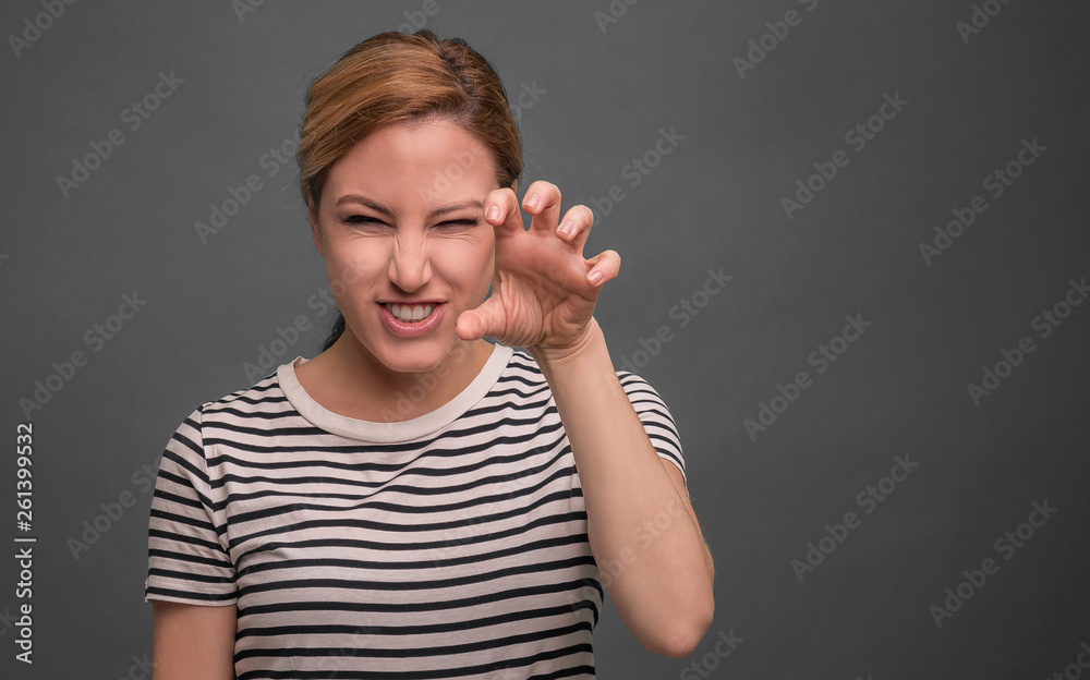 Beautiful young woman showing claws. Beautiful young woman showing claws.