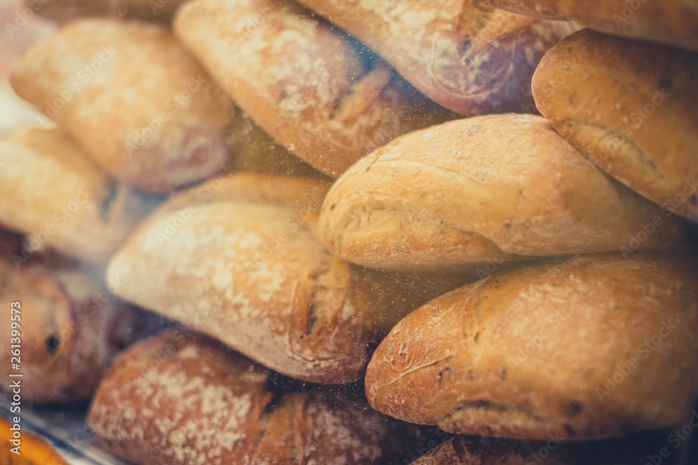 fresh baguette bread rolls closeup for sale at bakery   -
