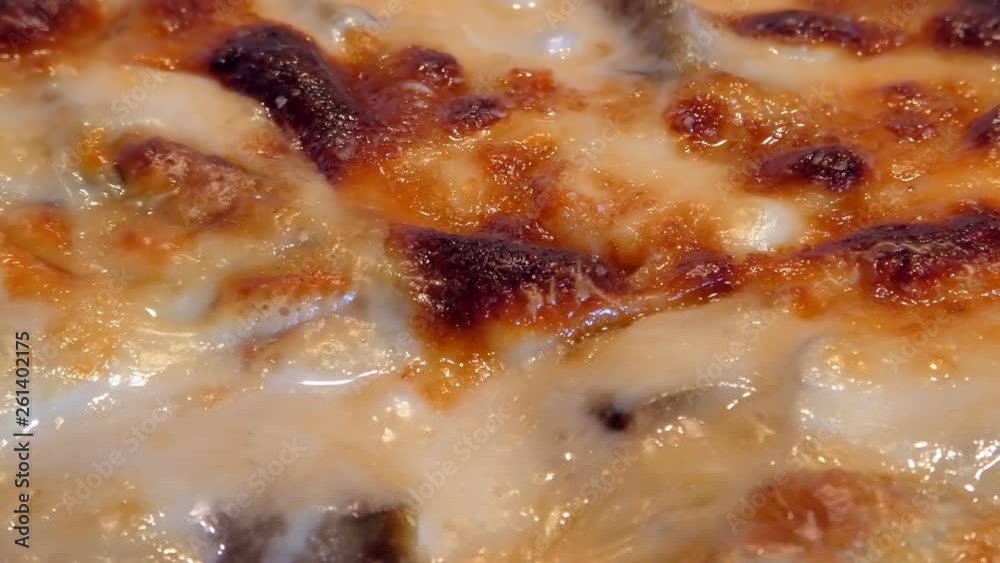 baking Moussaka with vegetables, cheese and bechamel, boiling hot in an oven. Traditional greek dish. Close up zooming out. baking Moussaka with vegetables, cheese and bechamel, boiling hot in an oven. Traditional greek dish. Close up zooming out.