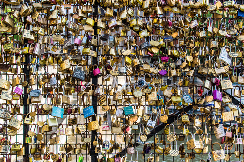 Love locks from a bridge in Paris, France. It is a tradition for a couple to place a lock on a bridge and throw the keys into the river to signify their love.