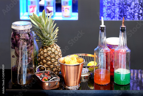 Still life with ingredients for cocktails on bar counter front view closeup