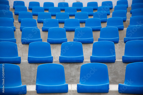 Tennis Court, empty blue seats.