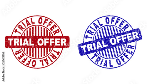 Grunge TRIAL OFFER round watermarks isolated on a white background. Round seals with grunge texture in red and blue colors. Vector rubber watermark of TRIAL OFFER tag inside circle form with stripes.