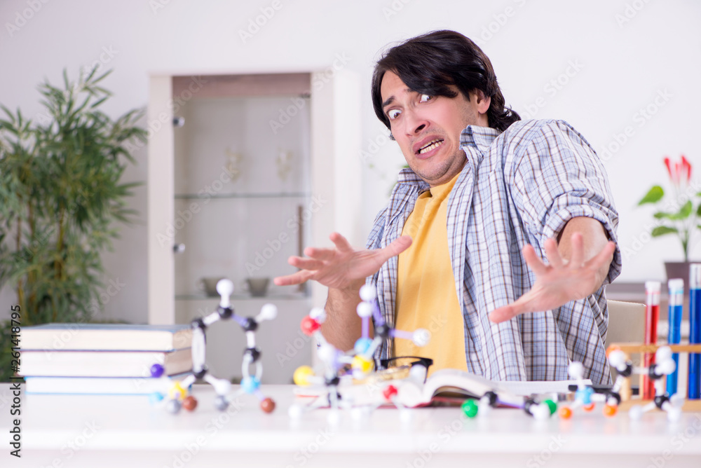 Young student physicist preparing for exam at home Young student physicist preparing for exam at home