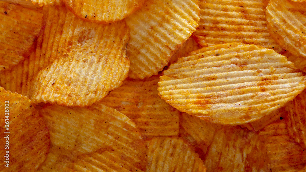 Texture fried golden brown potato chips, close-up Texture fried golden brown potato chips, close-up