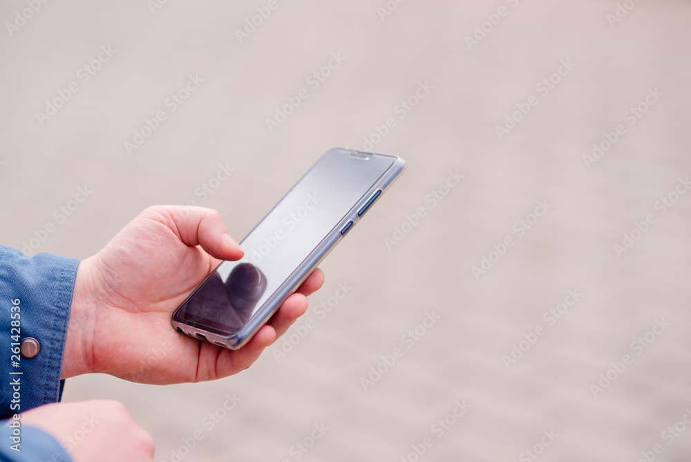 Hands young man phone for searching educating on Internet. Online bank, Internet security horizontal view Hands young man phone for searching educating on Internet. Online bank, Internet security horizontal view