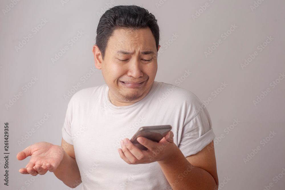 Young Man Texting Reading Chatting on His Phone Sad Crying Young Man Texting Reading Chatting on His Phone Sad Crying